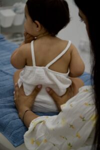 Bump and Beyond chiropractor providing gentle back treatment for a baby in Wimbledon clinic