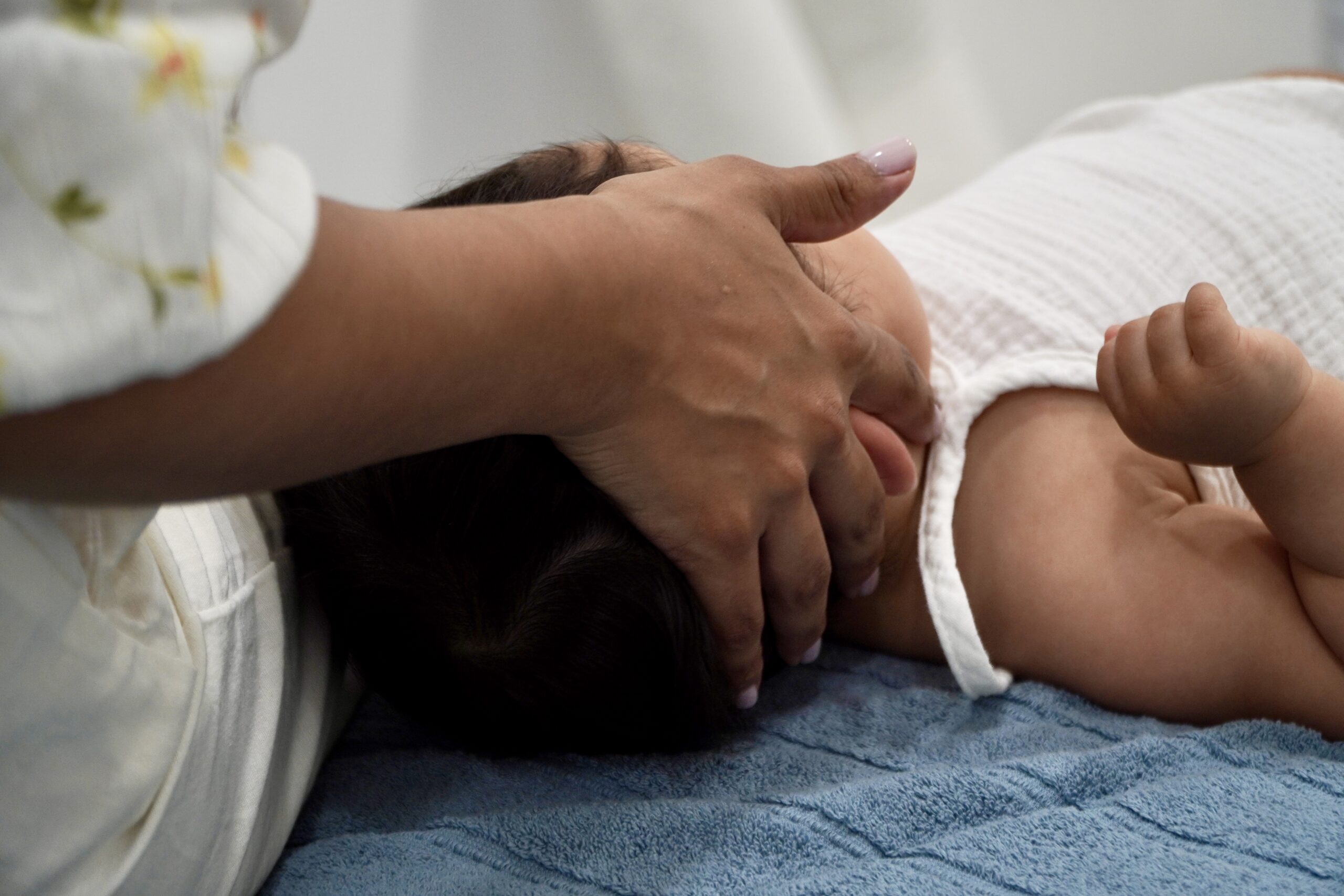 Baby receiving gentle chiropractic care at Bump and Beyond Clinic in Wimbledon.