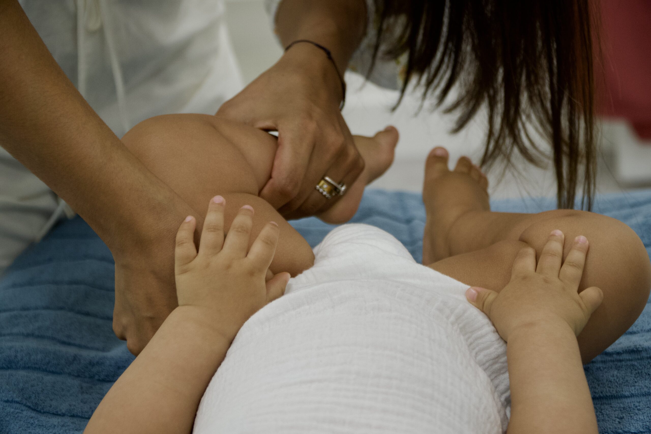 Chiropractor gently holding a baby during a chiropractic session.