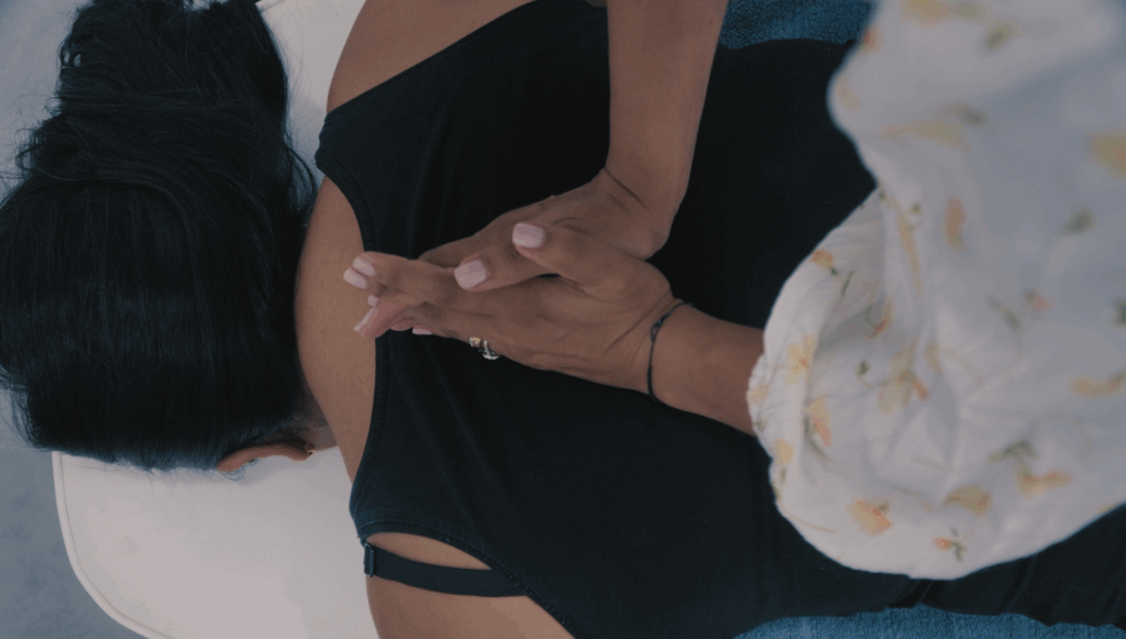Chiropractor performing soft tissue therapy on a patient as part of holistic care.