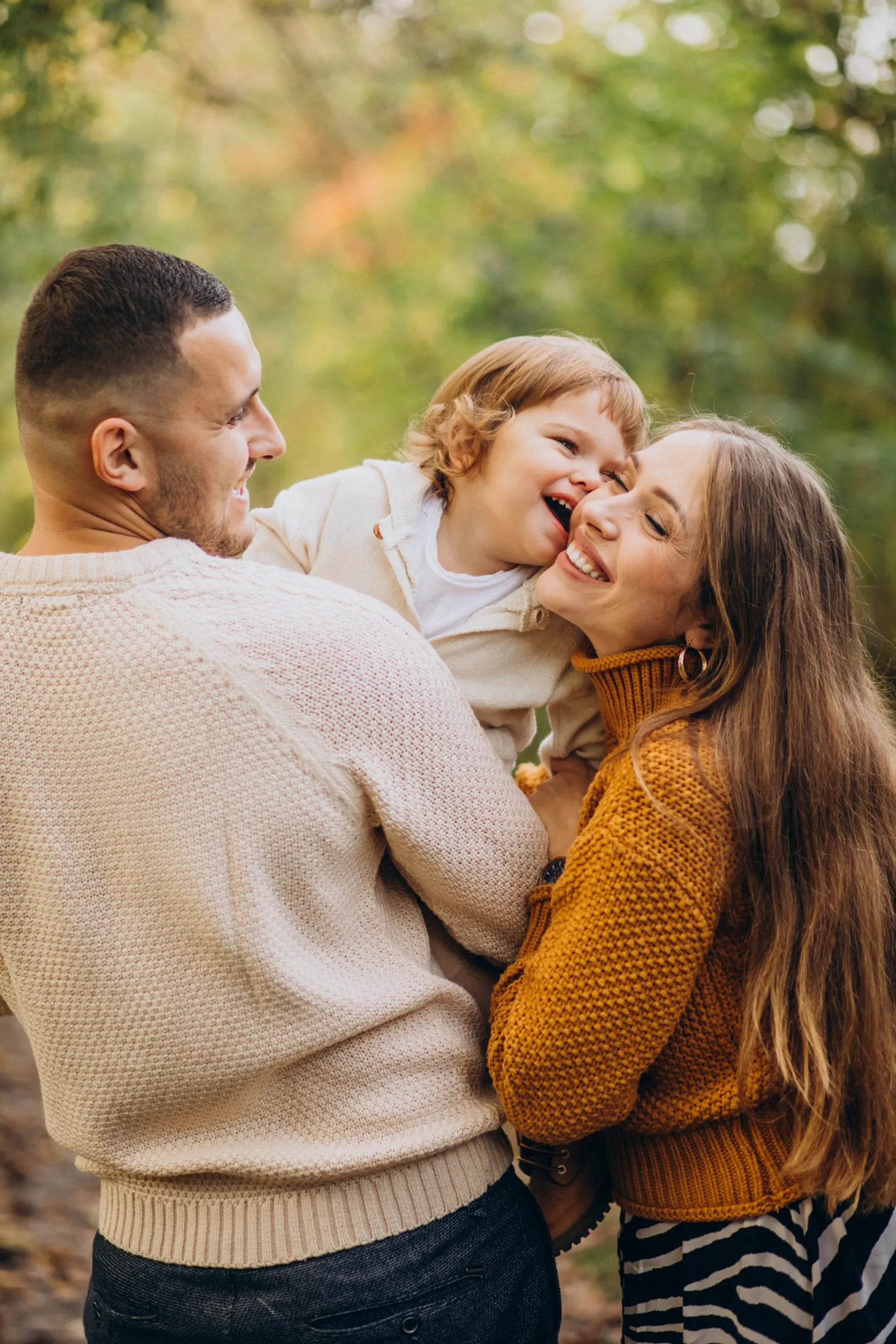 Family with young child smiling together